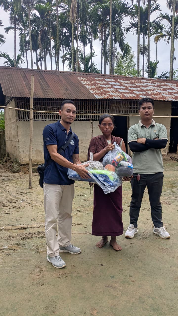 Flood-relief supplies being handed to an affected household in Kaibong Tisso Village.