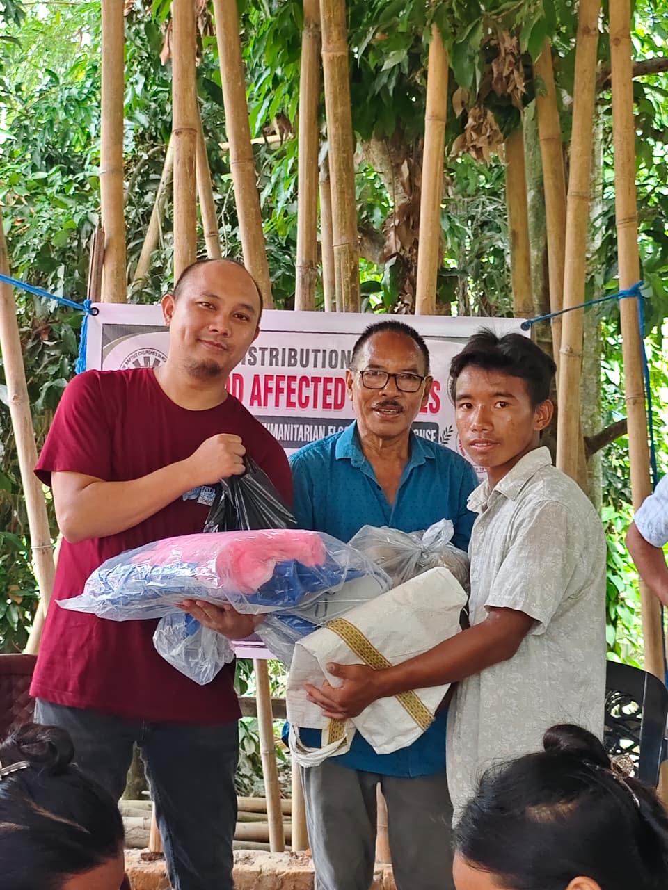 A flood-affected household receiving relief supplies