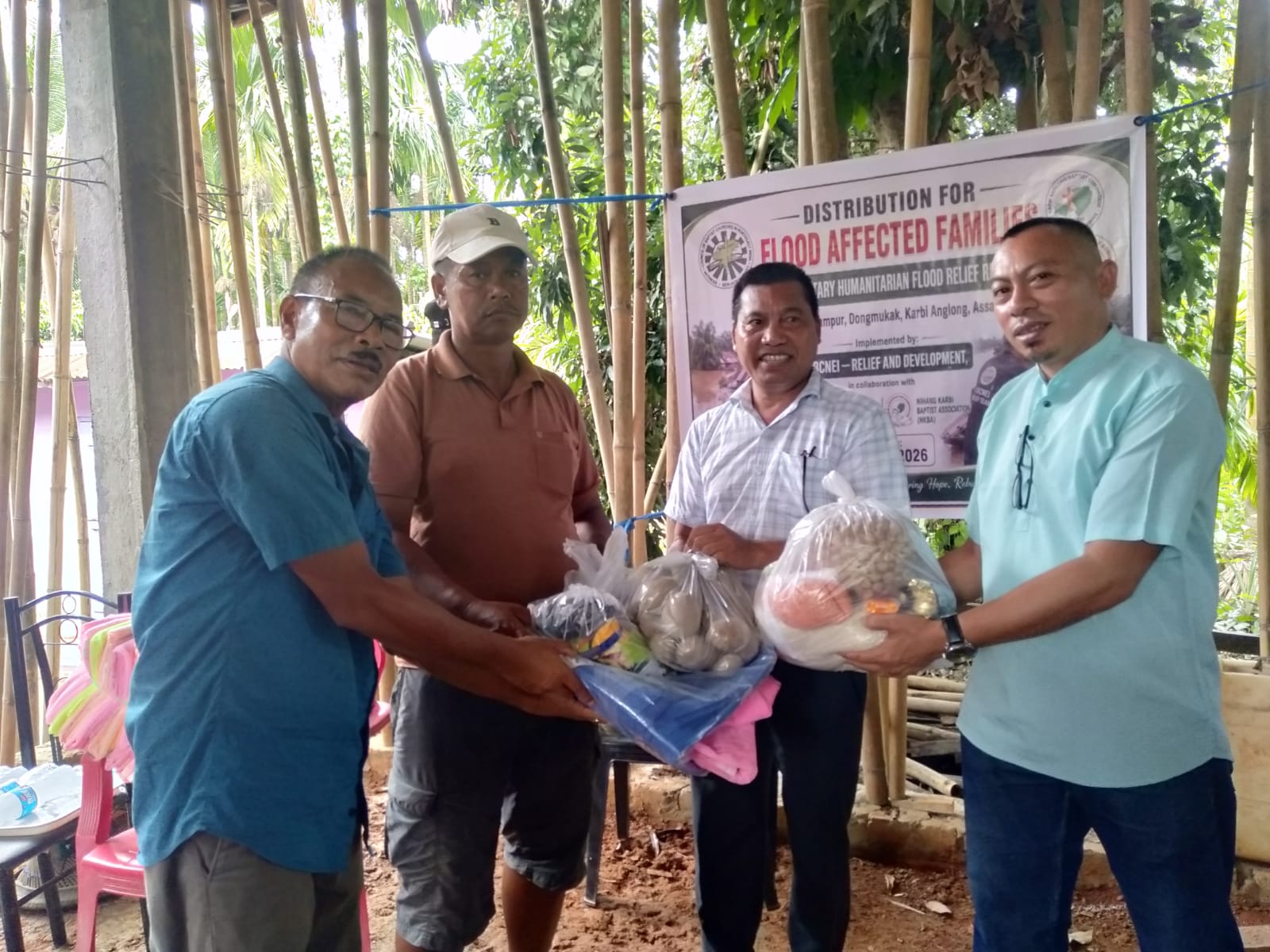 Relief team members distributing supplies to flood-affected families