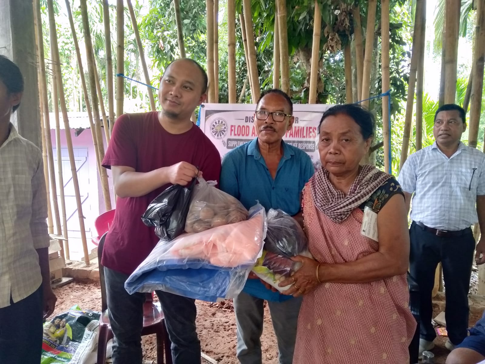 Relief supplies being handed to a flood-affected family member
